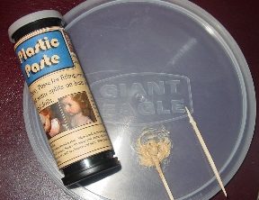 A candle labeled "Santo Muerte" beside a skull and crossbones symbol.